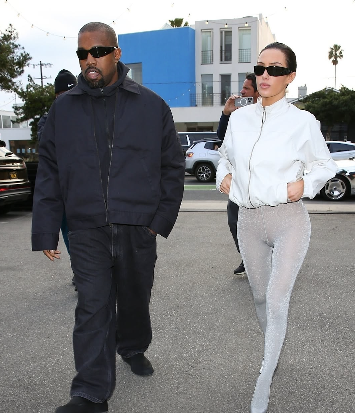 Kanye West i jego nowa partnerka w lustrzanym selfie – Artystyczne ujęcie, na którym Kanye West ubrany w czarny t-shirt i spodnie pozuje do selfie z tajemniczą kobietą w eleganckiej, czarnej sukience. Zdjęcie podkreśla minimalistyczny, nowoczesny styl Westa, który po rozwodzie z Kim Kardashian wciąż pozostaje ikoną mody.